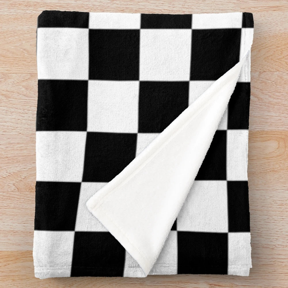 Checkered plush blanket in black and white geometric pattern