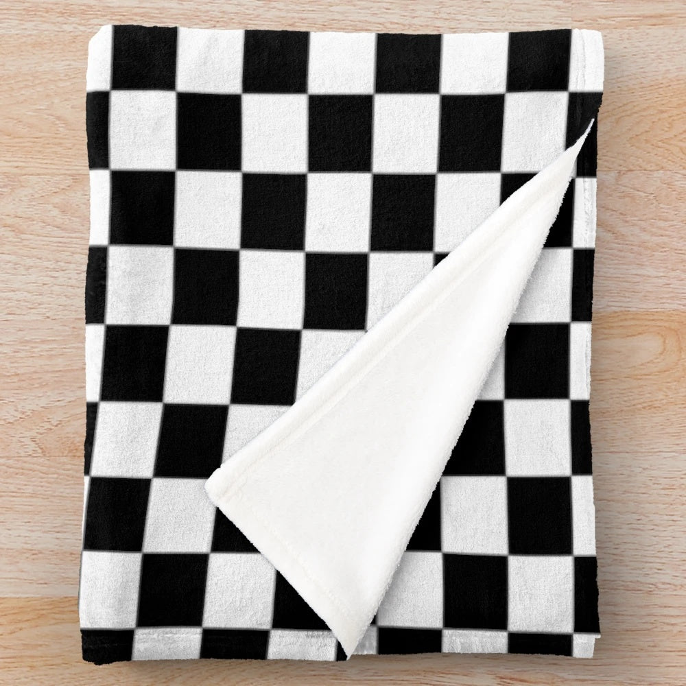Checkered plush blanket with ska music inspired black and white checkered pattern