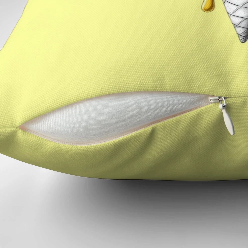 A soft, yellow pillow with a happy, expressive ice cream design