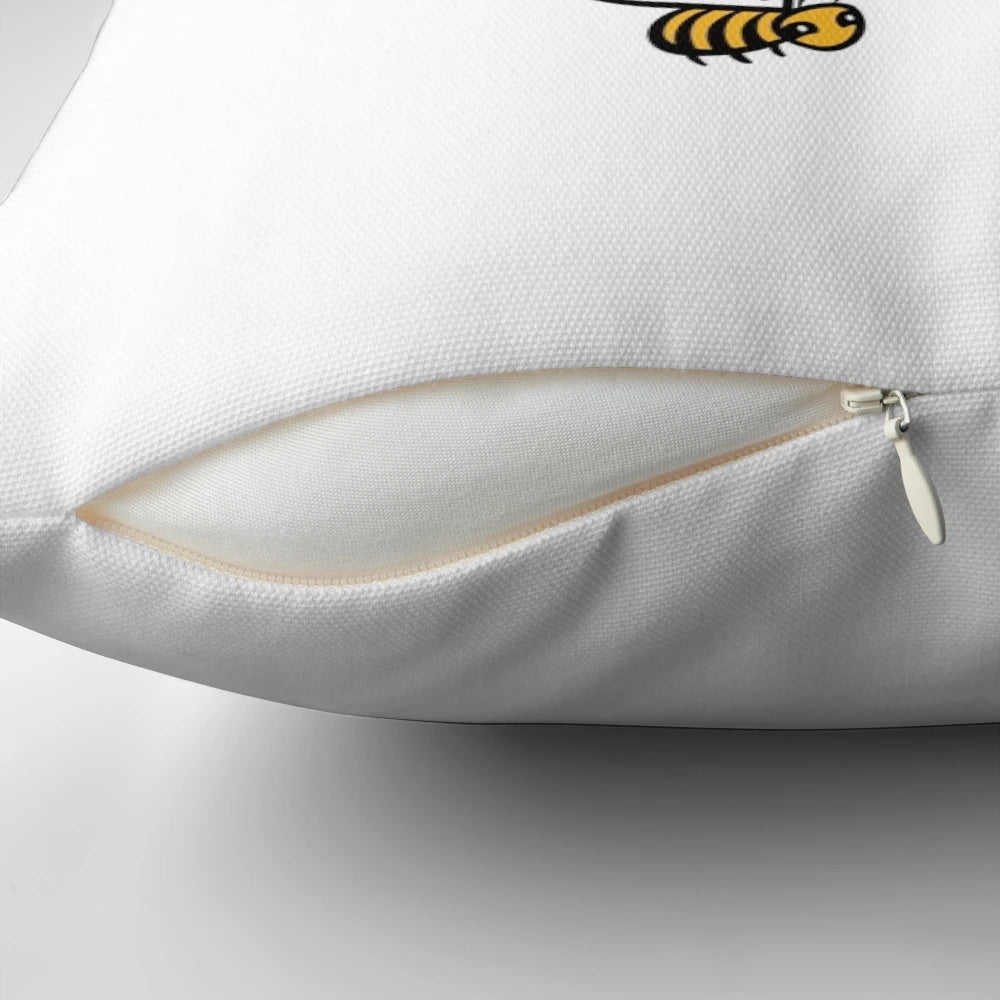 Bright yellow bee-themed pillow with "Bee Happy" lettering