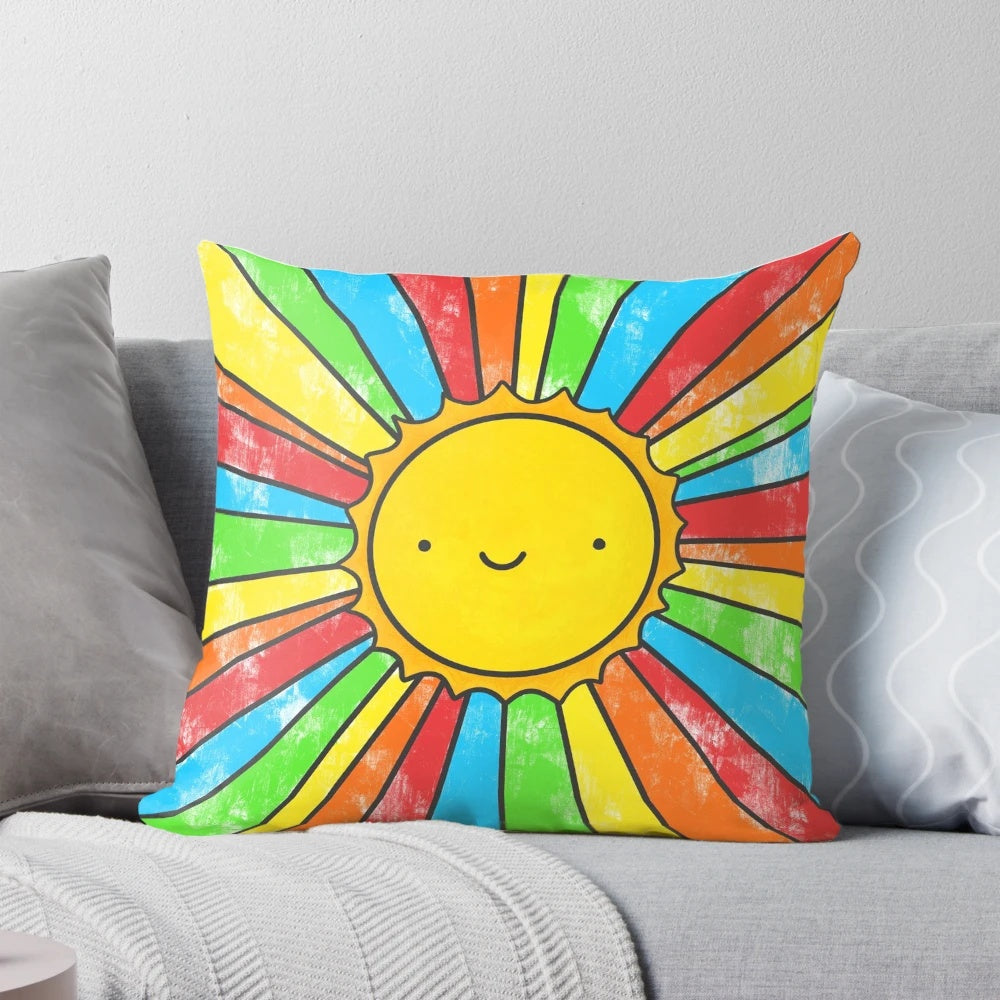 Colorful pillow with sun, rainbow, and positive quote design