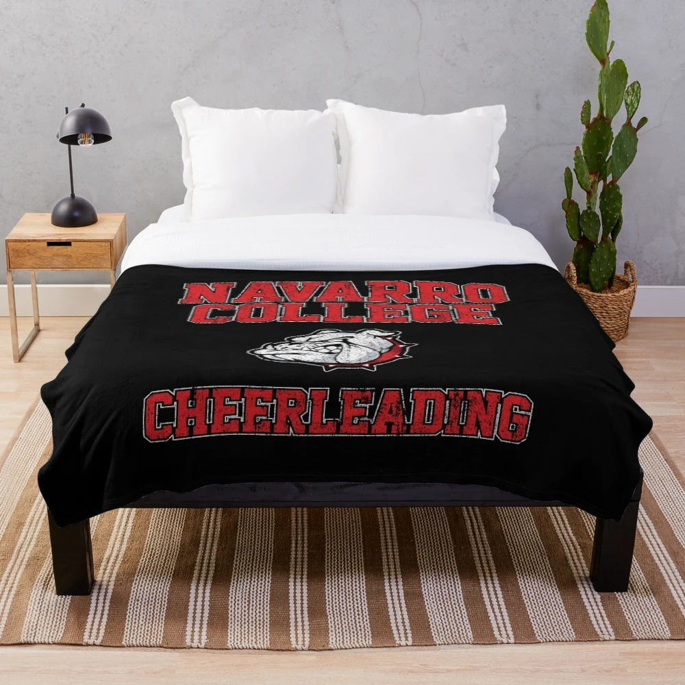 Cheerleading plush blanket featuring the Navarro Bulldogs logo and team colors