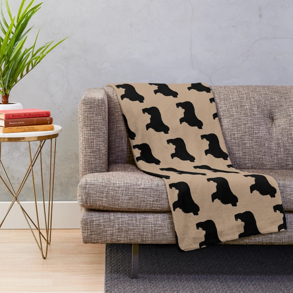 Newfoundland dog (Newfie) on a plush blanket