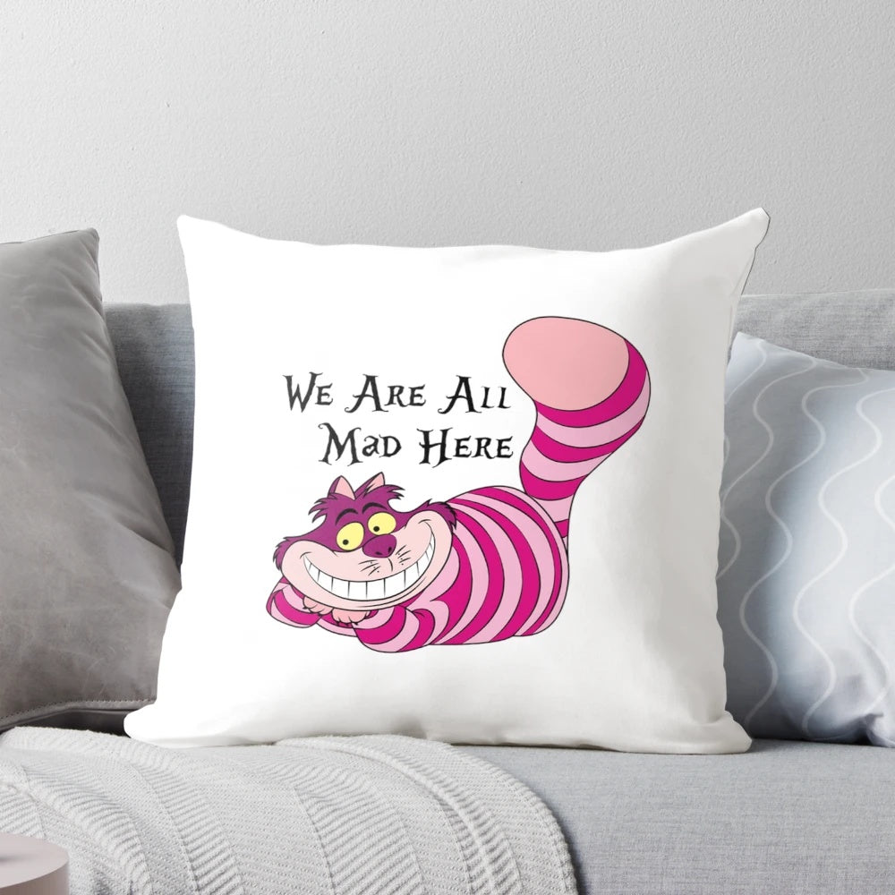 Cheshire Cat decorative throw pillow with a vintage-style illustration and the quote "We're all mad here