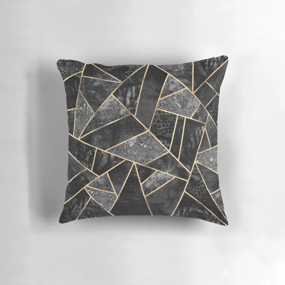 Stylish abstract black and gold throw pillow with a modern geometric mosaic design