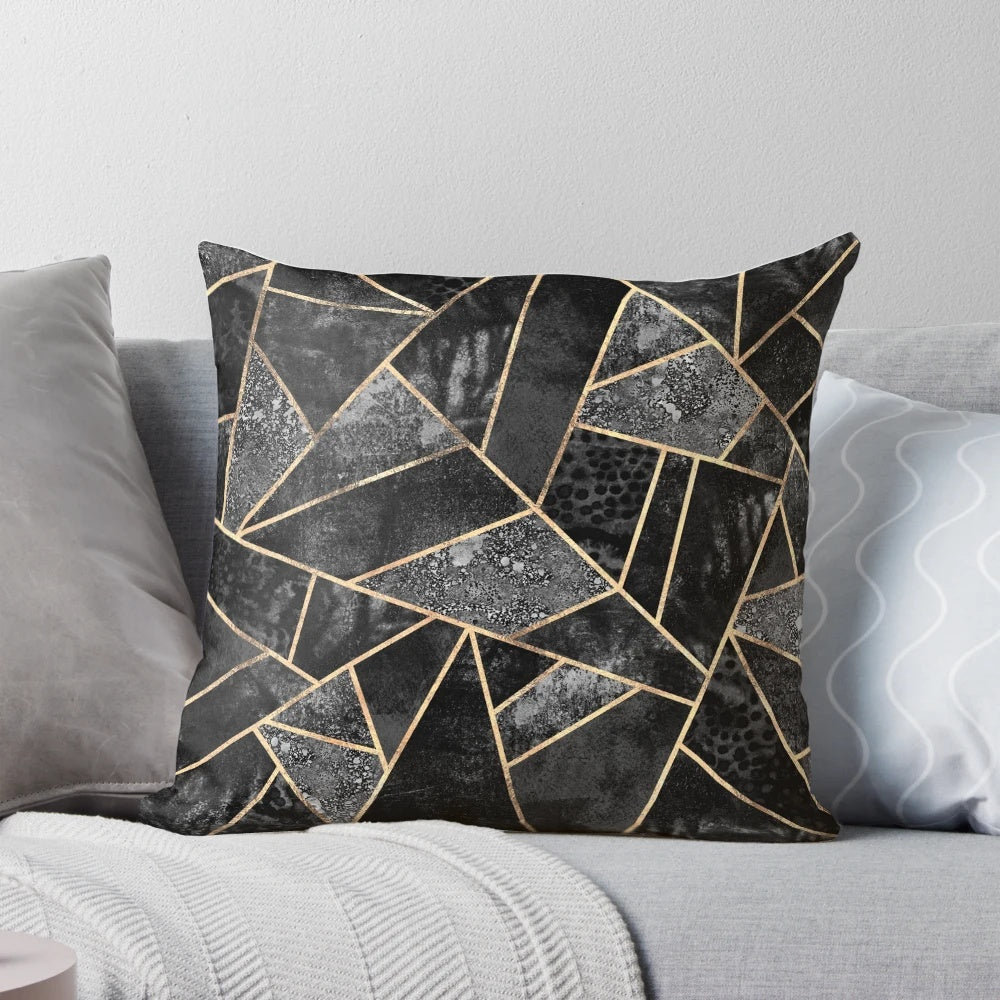 Stylish abstract black and gold throw pillow with a modern geometric mosaic design