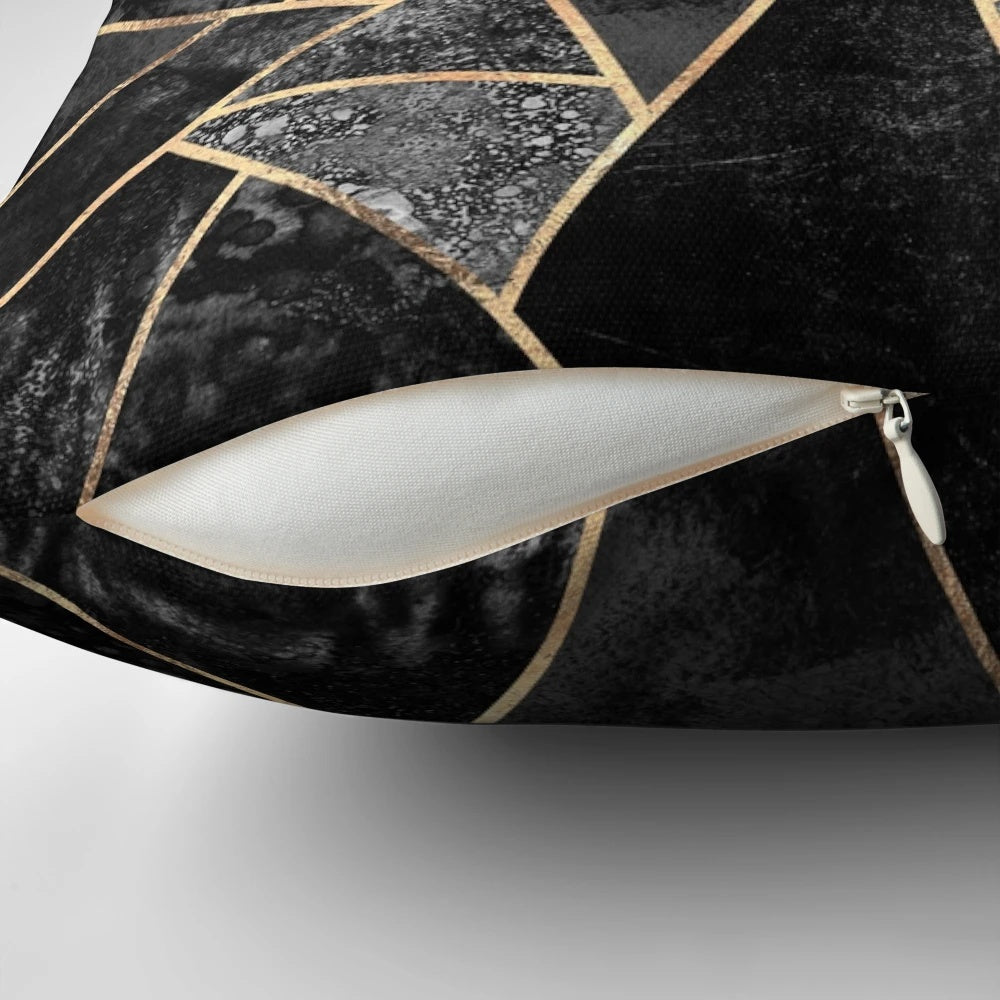 Stylish abstract black and gold throw pillow with a modern geometric mosaic design