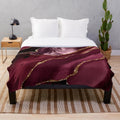 Burgundy and gold abstract patterned plush blanket