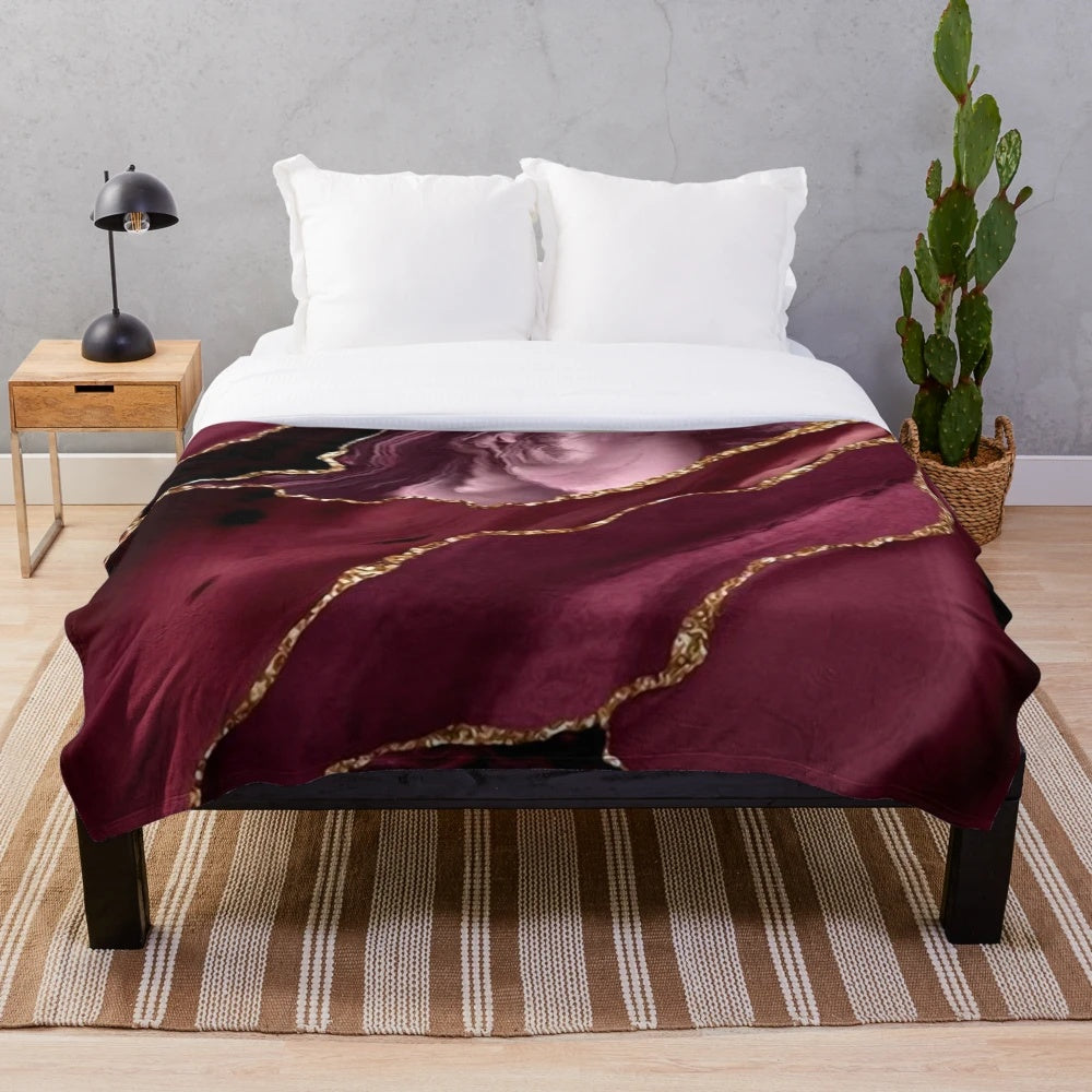 Burgundy and gold abstract patterned plush blanket