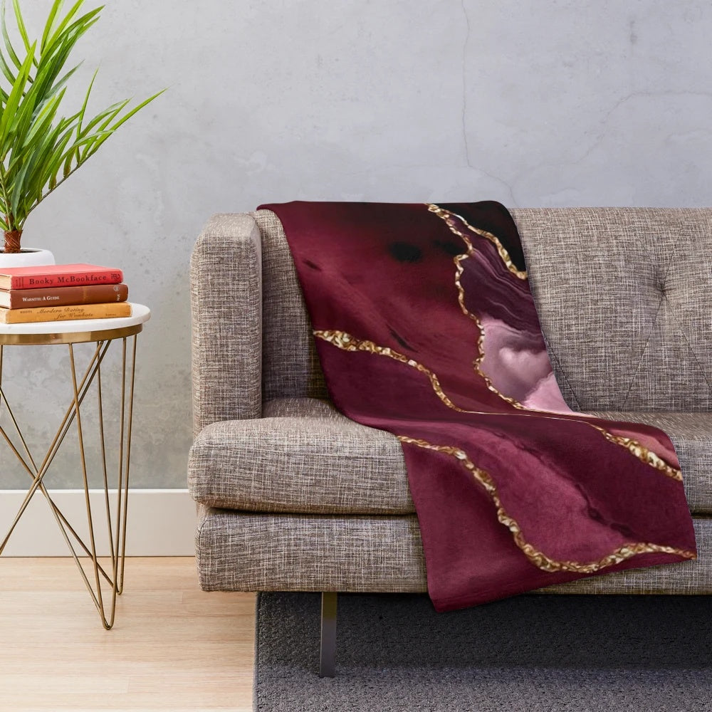 Burgundy and gold abstract patterned plush blanket