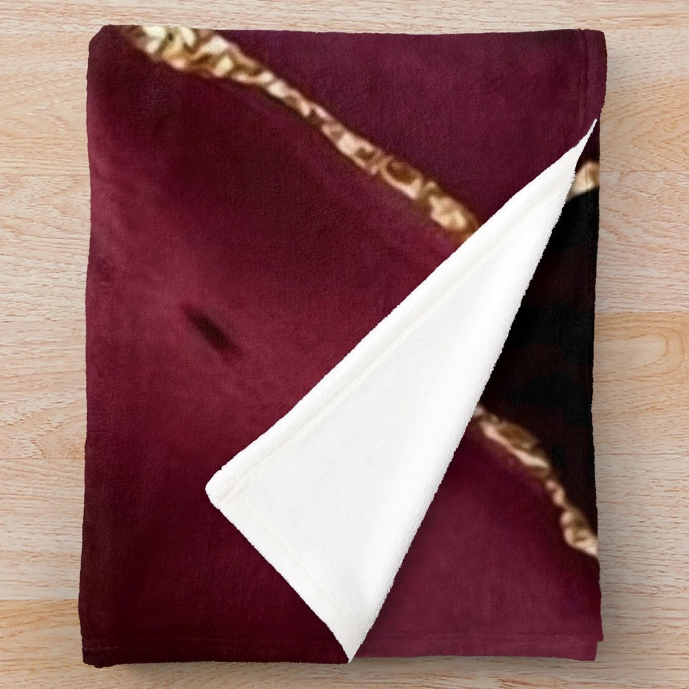 Burgundy and gold abstract patterned plush blanket