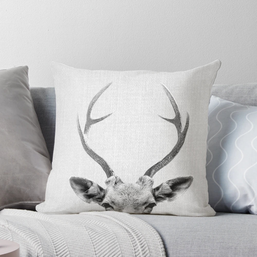 Minimalist black and white deer pillow with antlers and head design