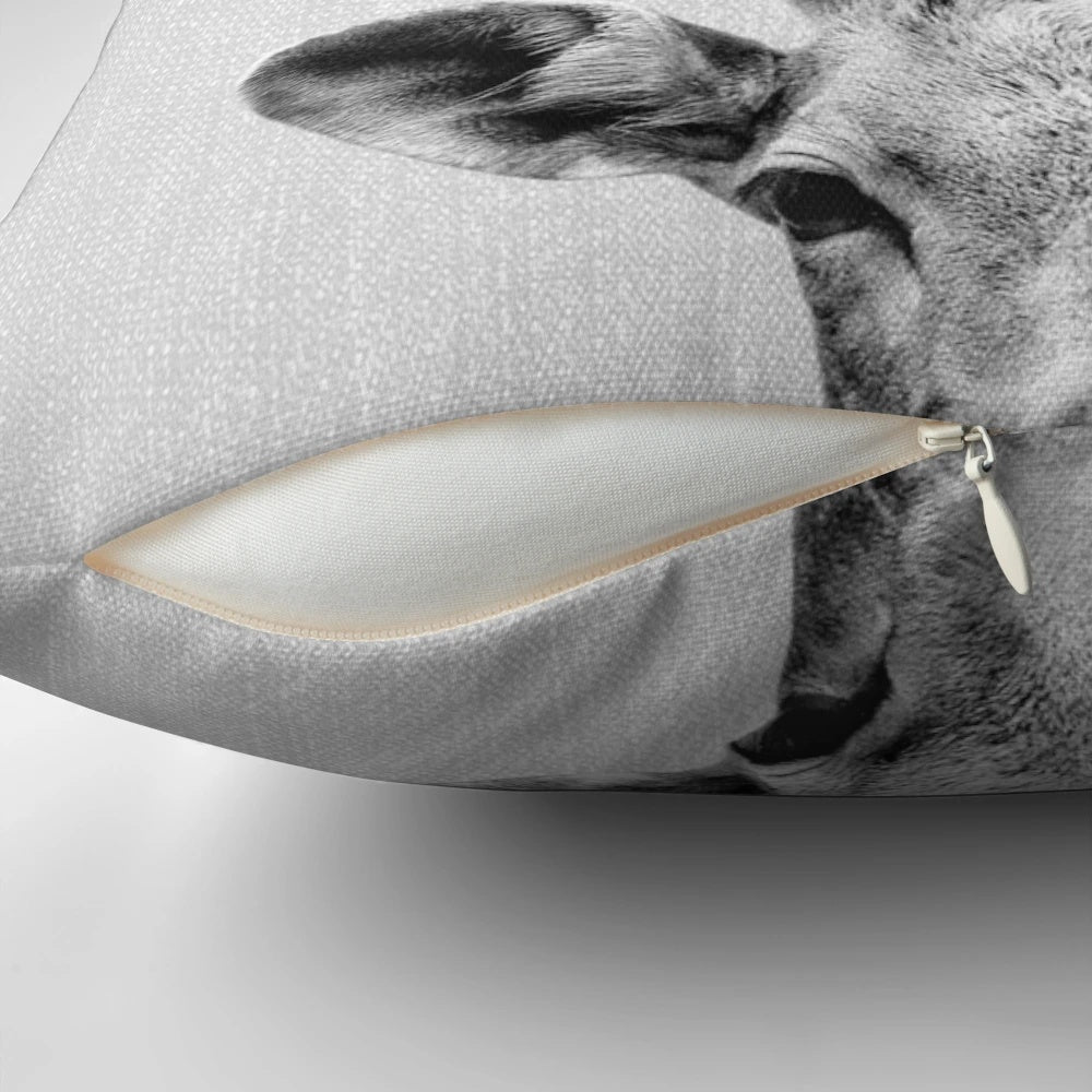 Minimalist black and white deer pillow with antlers and head design