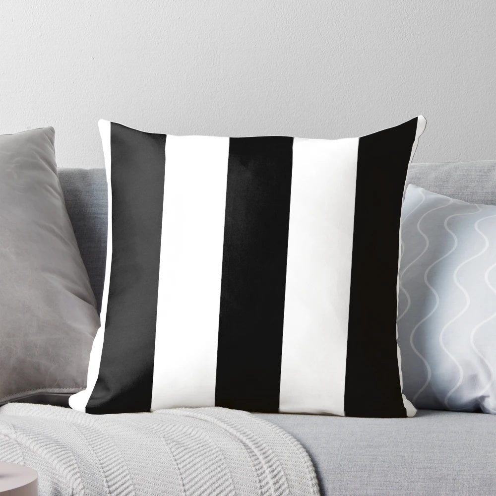 Black and white striped pillow with an awning-inspired design from rewstudio