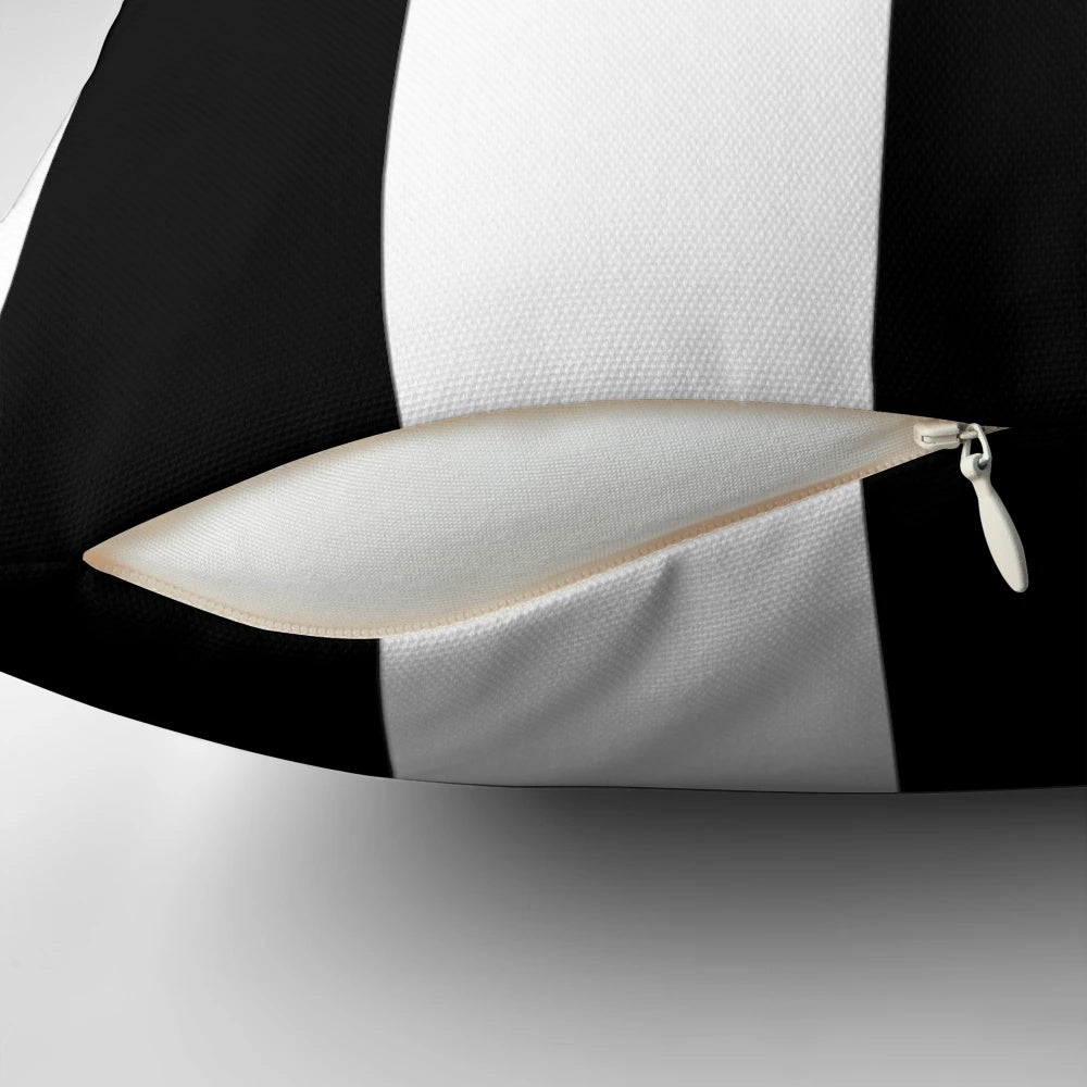Black and white striped pillow with an awning-inspired design from rewstudio