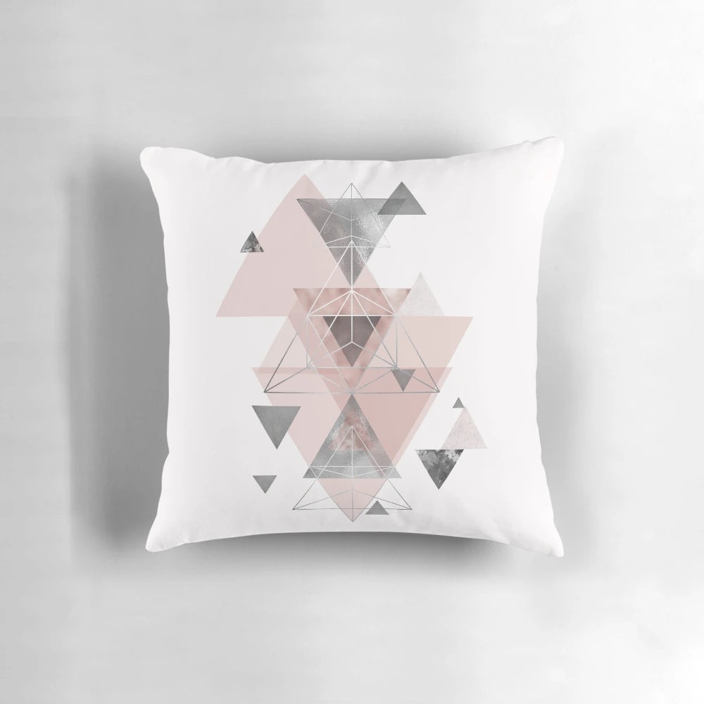 Soft, modern accent pillow featuring an abstract geometric pattern in soothing blush pink and grey tones.