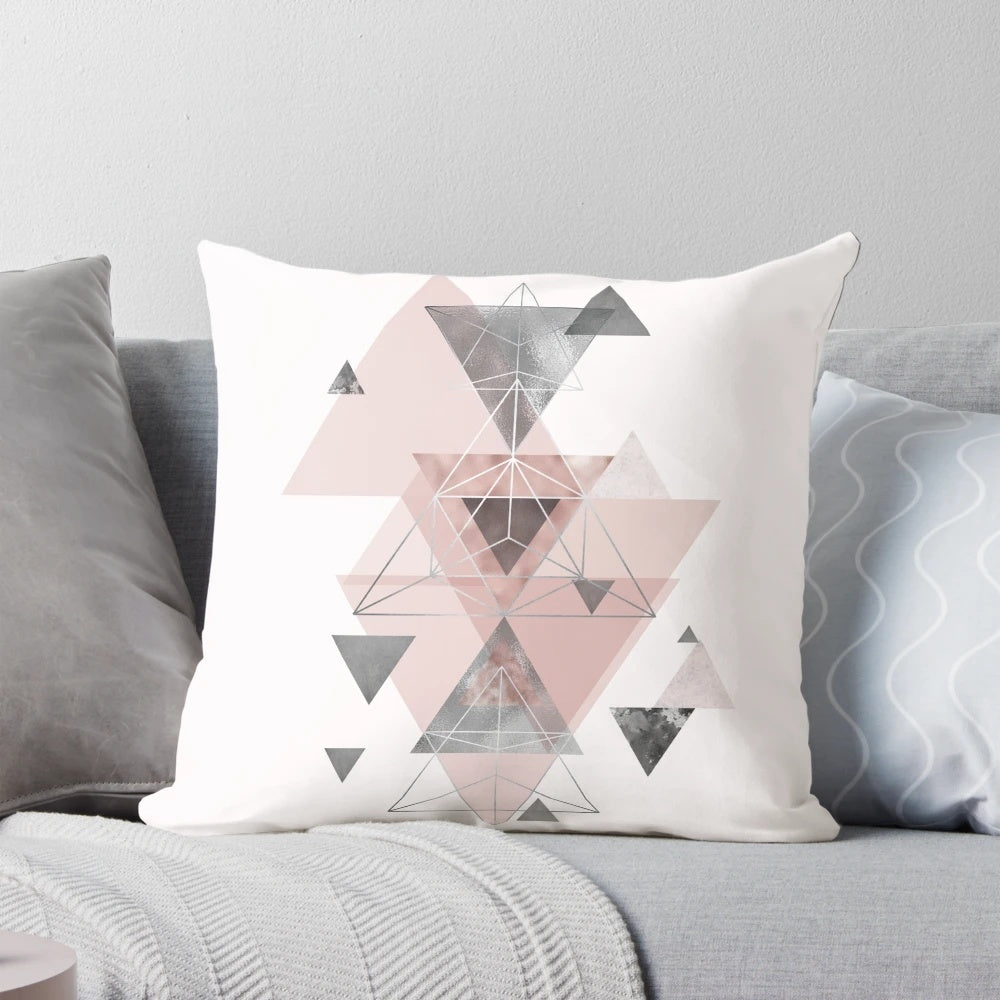 Soft, modern accent pillow featuring an abstract geometric pattern in soothing blush pink and grey tones.