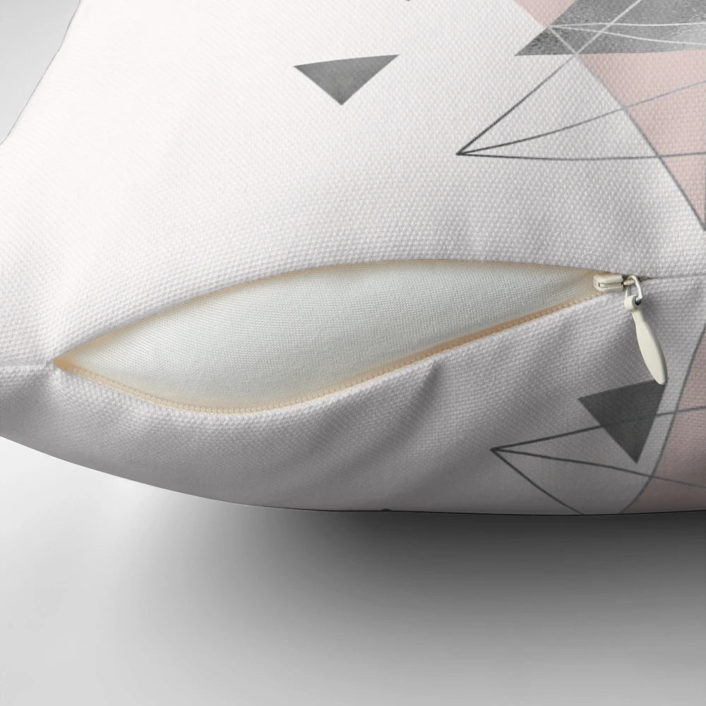 Soft, modern accent pillow featuring an abstract geometric pattern in soothing blush pink and grey tones.