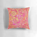 Close-up of a hot pink and gold baroque floral pattern pillow with a mandala-inspired design.