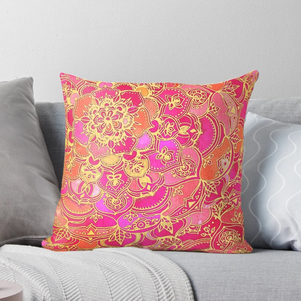 Close-up of a hot pink and gold baroque floral pattern pillow with a mandala-inspired design.
