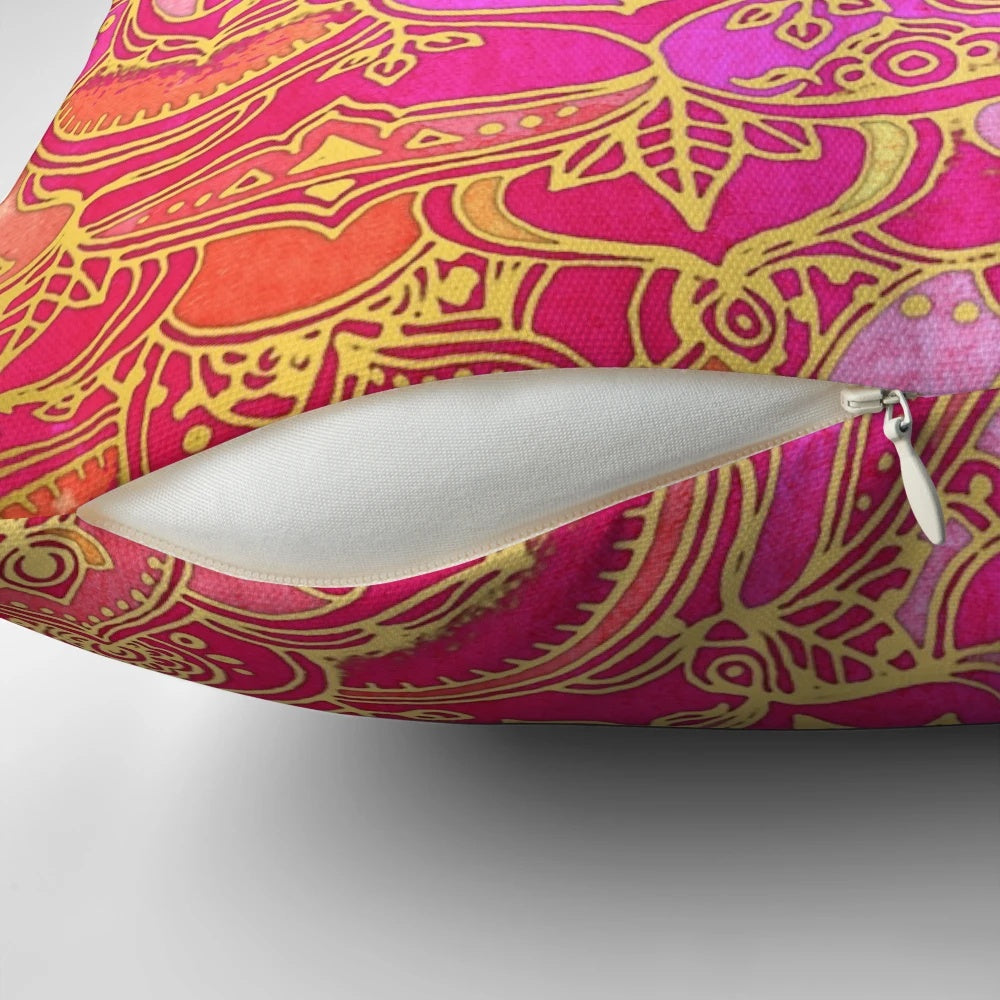 Close-up of a hot pink and gold baroque floral pattern pillow with a mandala-inspired design.