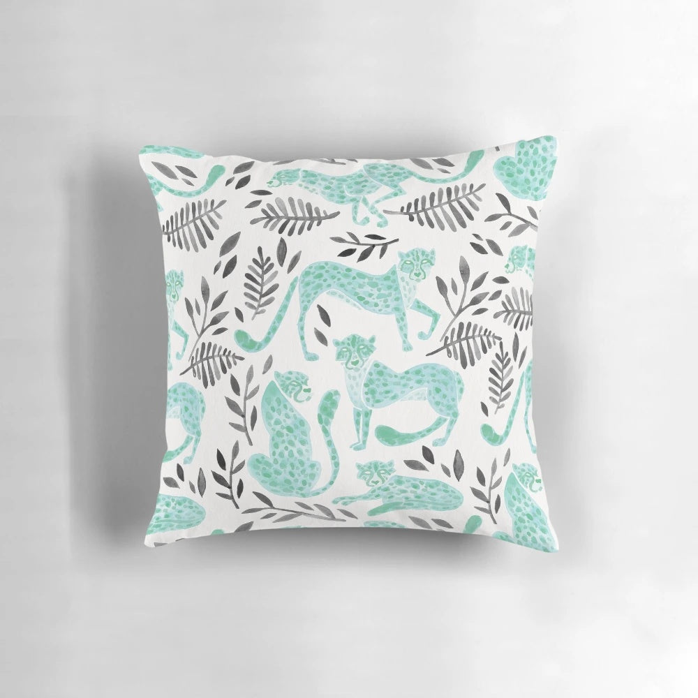 Vibrant cheetah print pillow with a modern black and mint color palette, perfect for adding a touch of safari-inspired style to your home.