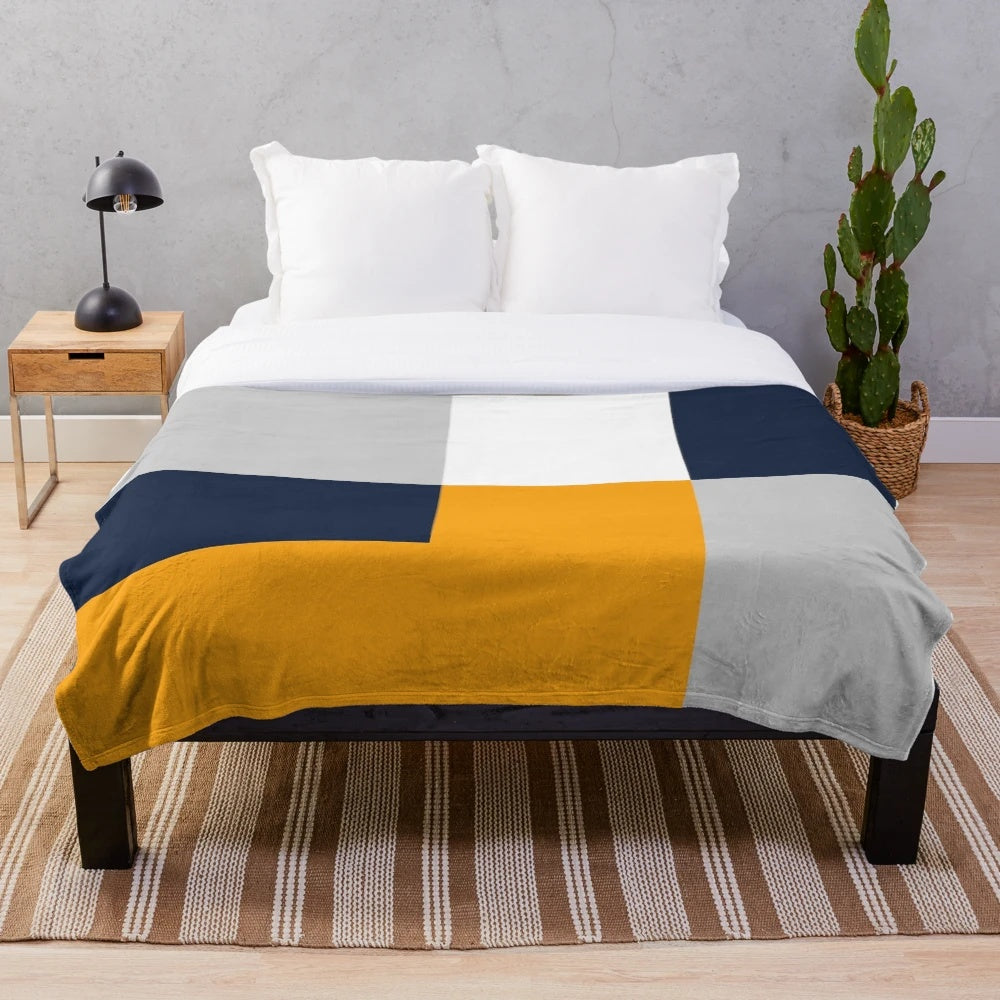 Stylish color block plush blanket in navy, grey, and yellow