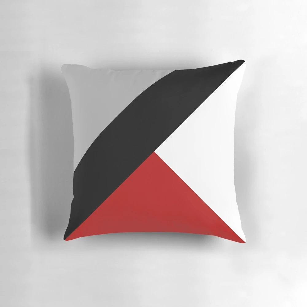 Black and white geometric throw pillow with diagonal stripes and triangular patterns, a minimalist and contemporary home decor accent.