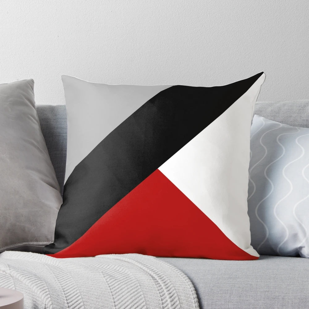 Black and white geometric throw pillow with diagonal stripes and triangular patterns, a minimalist and contemporary home decor accent.