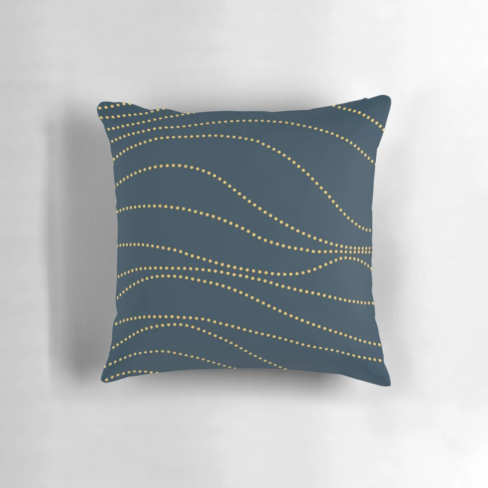 A modern, minimalist pillow in a sophisticated navy blue and mustard yellow pattern.