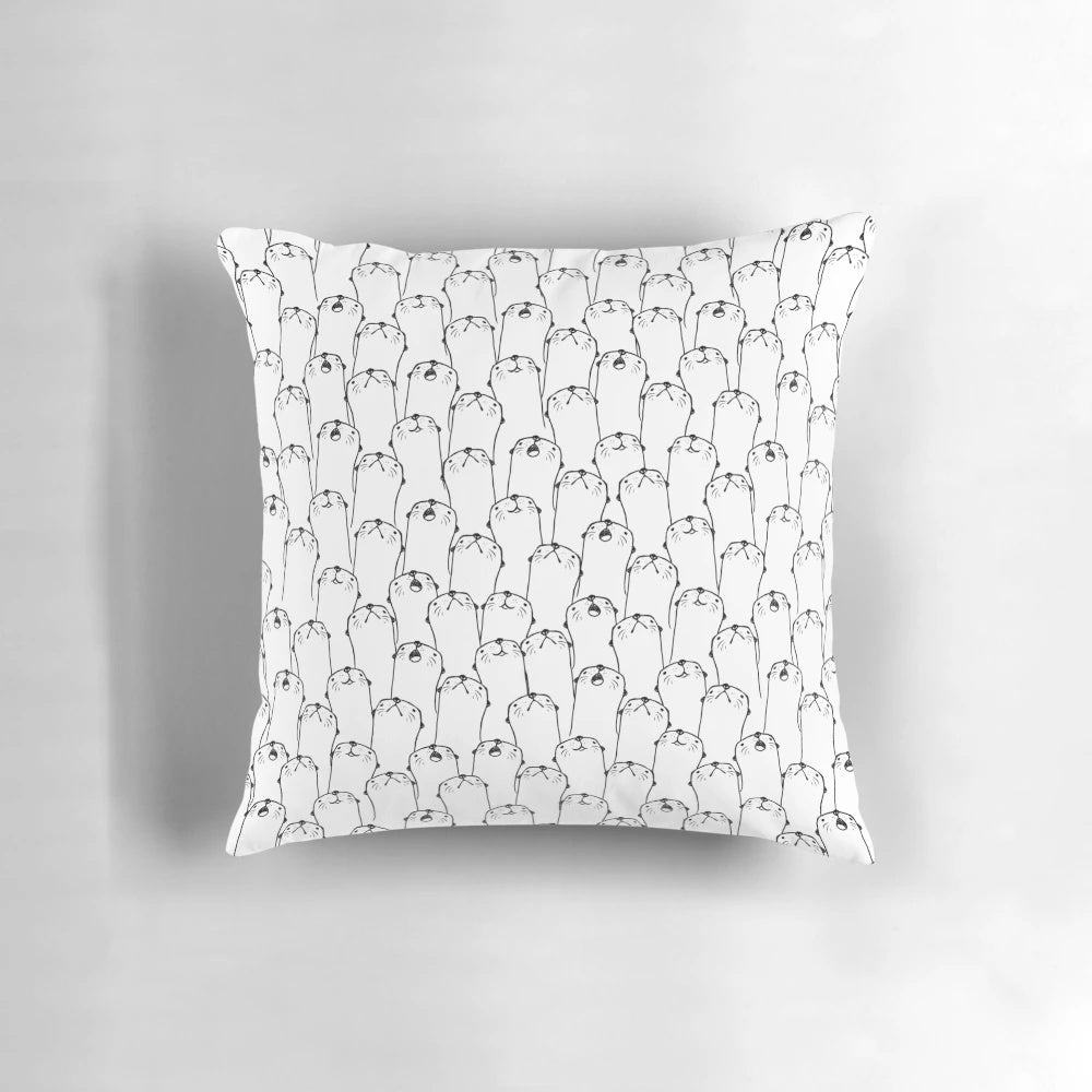 Decorative black and white pillow with a charming otter pattern design