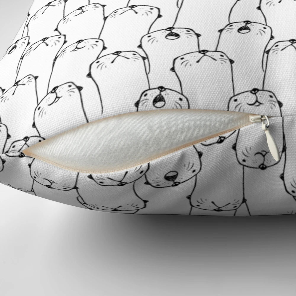 Decorative black and white pillow with a charming otter pattern design