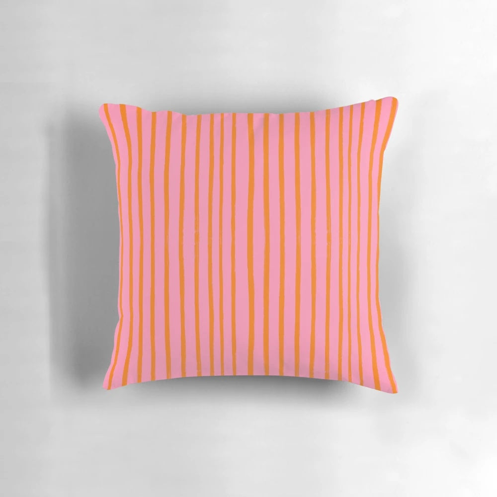 Stylish throw pillow with pink and orange brushstroke stripes for a preppy, summery look