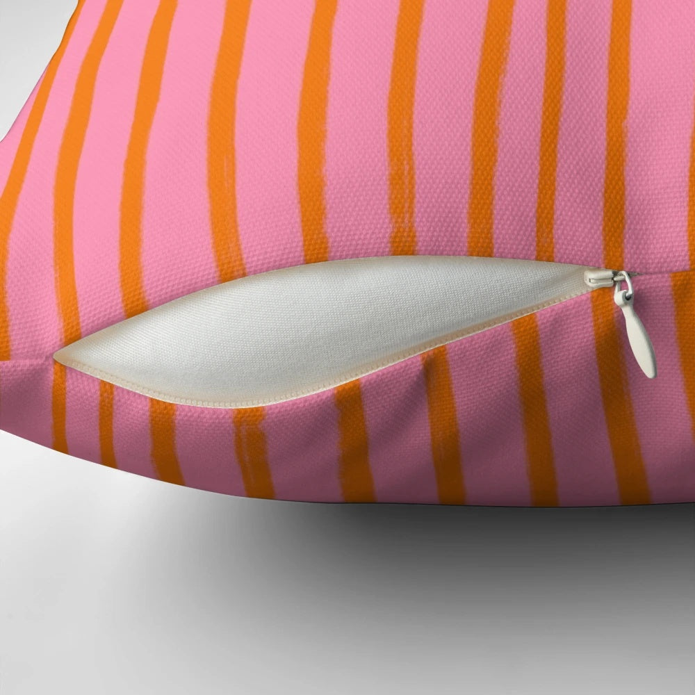 Stylish throw pillow with pink and orange brushstroke stripes for a preppy, summery look