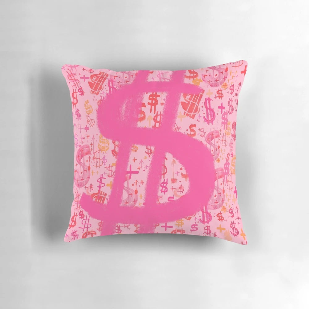 A vibrant pink throw pillow featuring a bold dollar sign graphic inspired by pop art and graffiti.