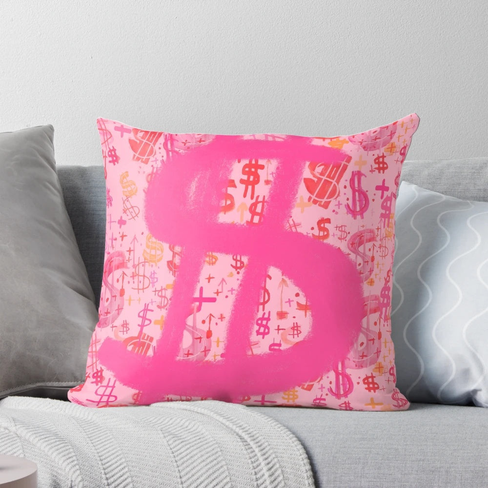 A vibrant pink throw pillow featuring a bold dollar sign graphic inspired by pop art and graffiti.