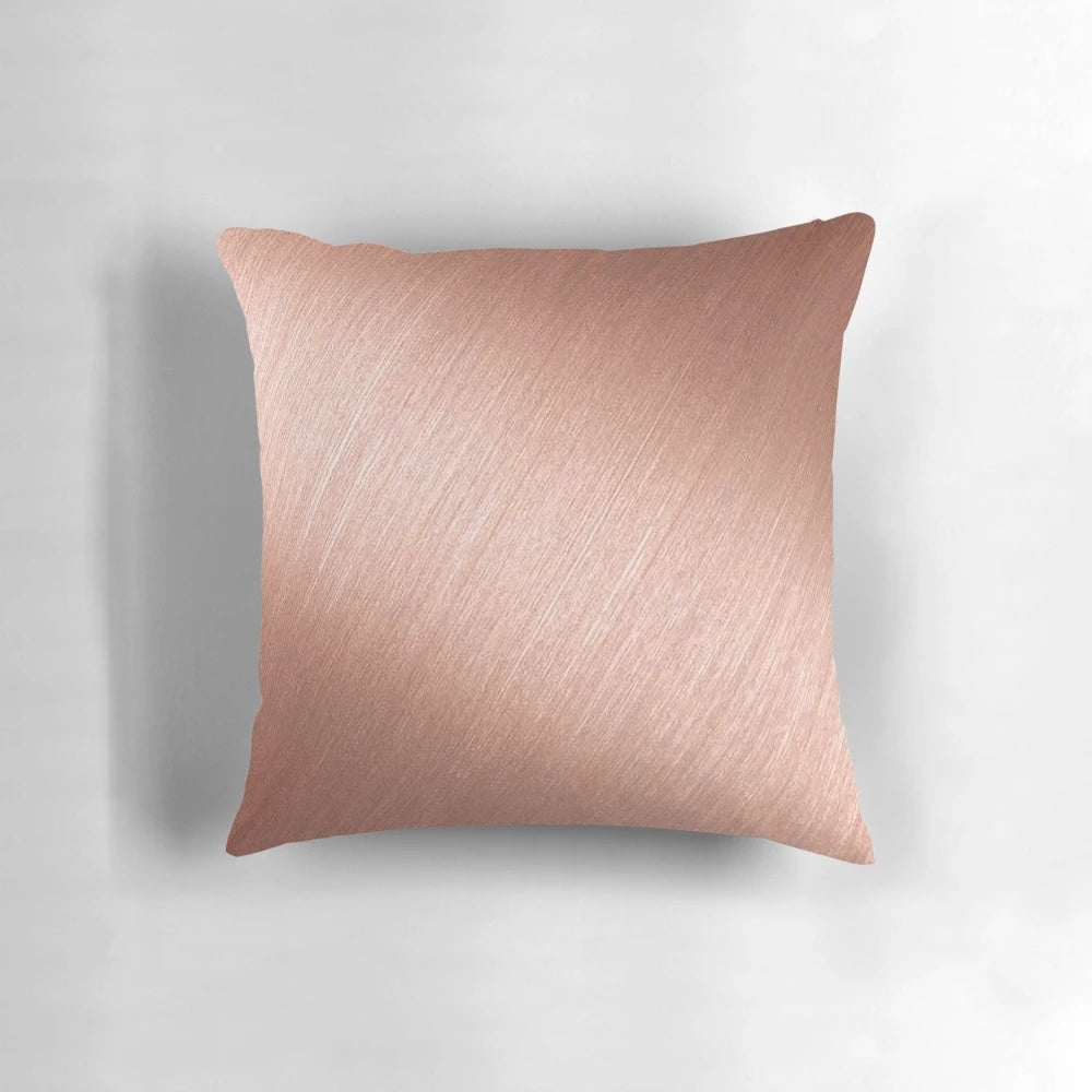 Rose gold reflective pillow with a modern, abstract design