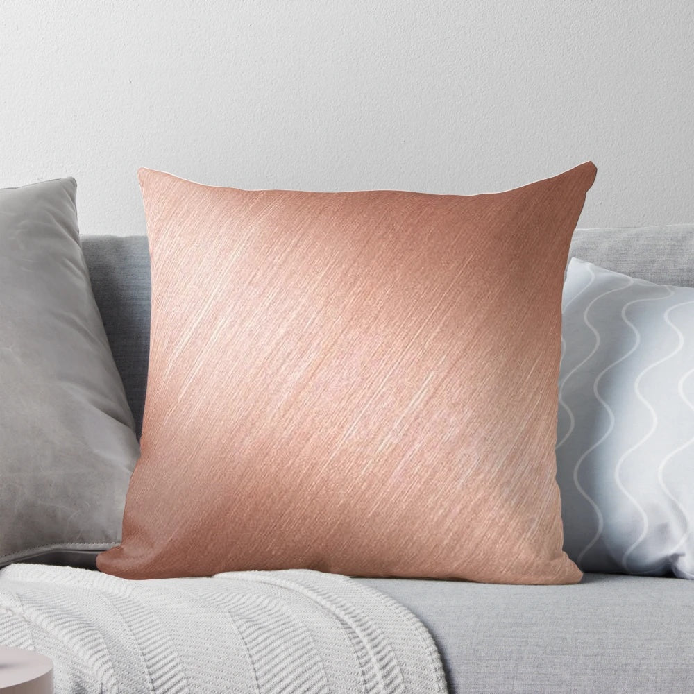 Rose gold reflective pillow with a modern, abstract design