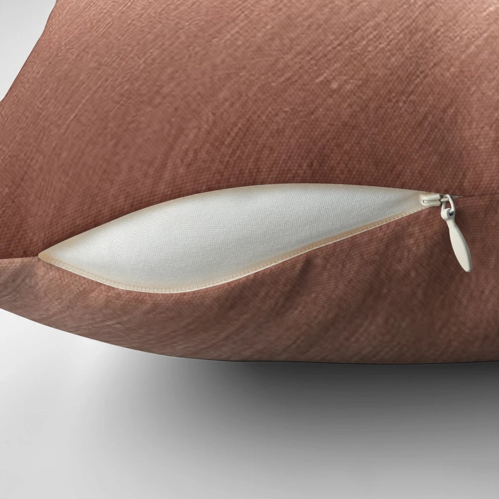Rose gold reflective pillow with a modern, abstract design