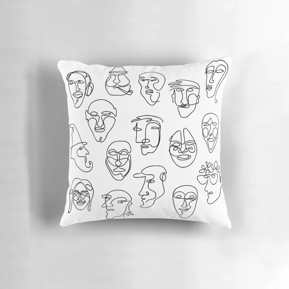 Throw pillow with a simple, hand-drawn line face design in black and white