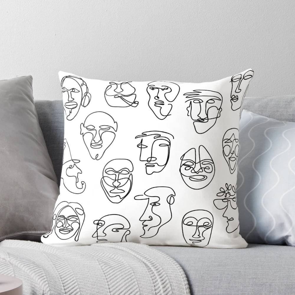 Throw pillow with a simple, hand-drawn line face design in black and white