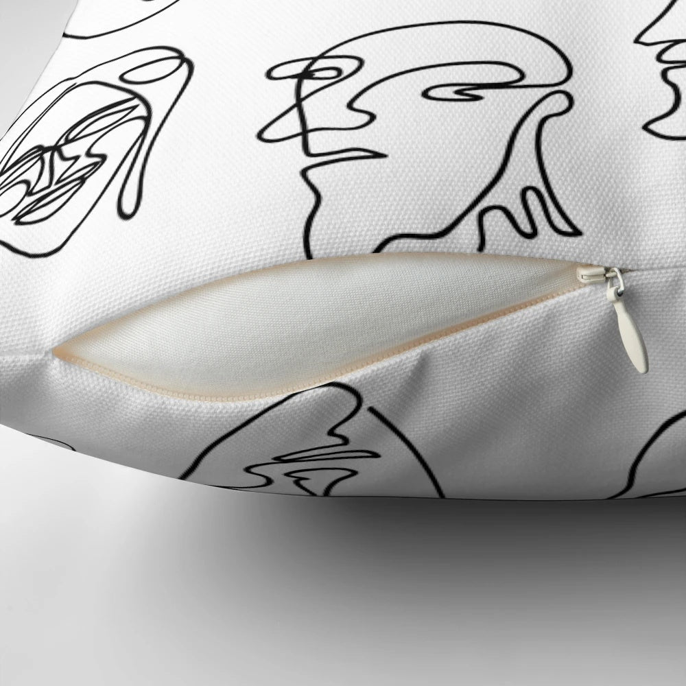 Throw pillow with a simple, hand-drawn line face design in black and white