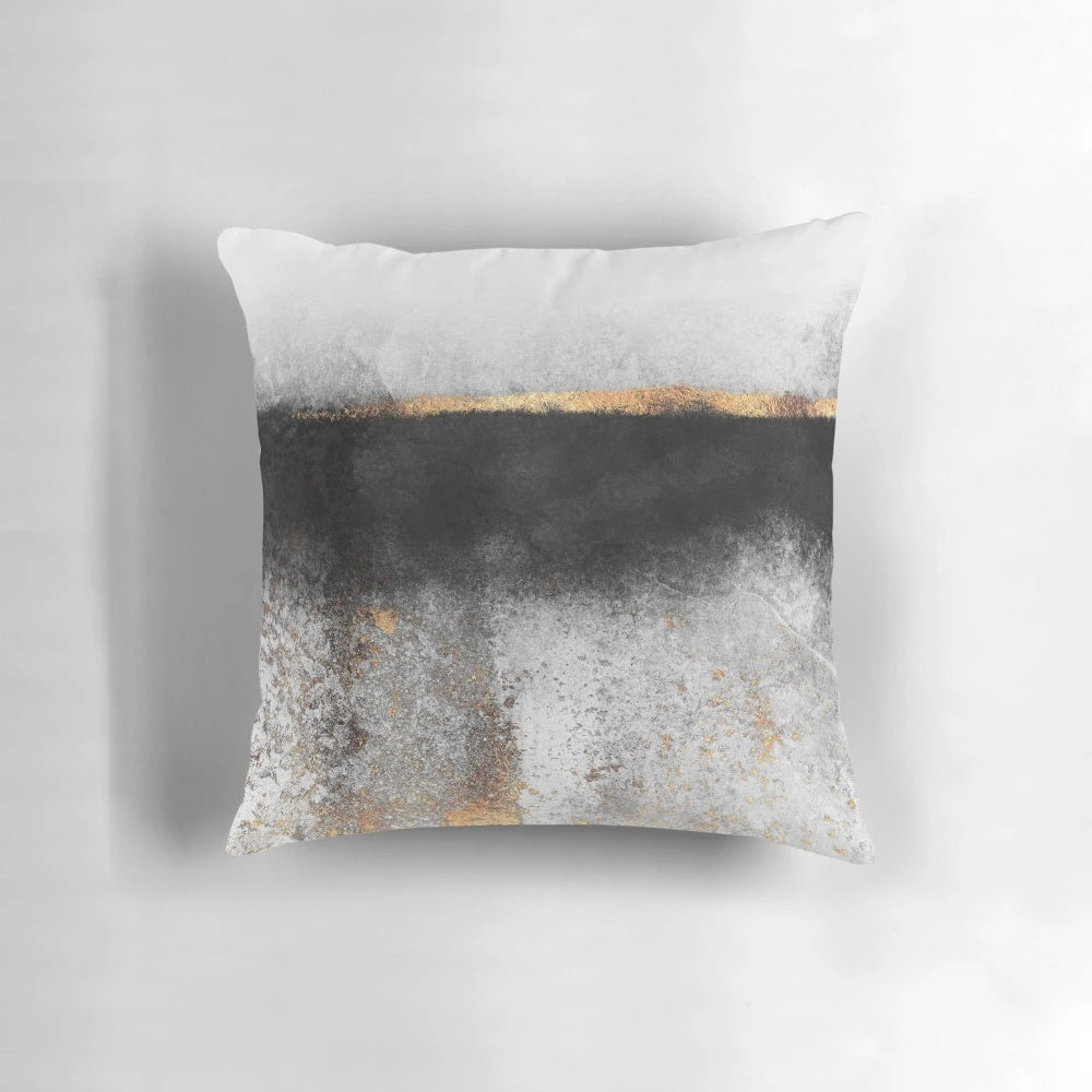 Soot and gold decorative pillow with a minimalist, abstract design