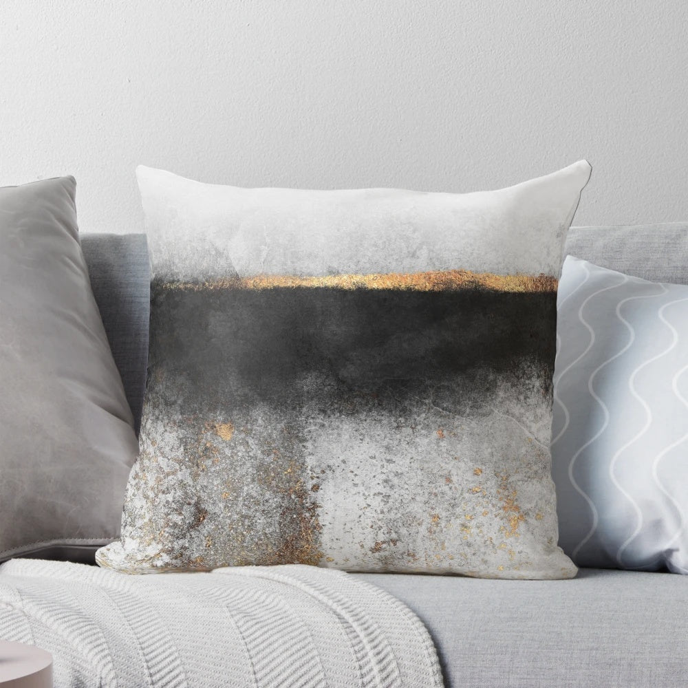 Soot and gold decorative pillow with a minimalist, abstract design
