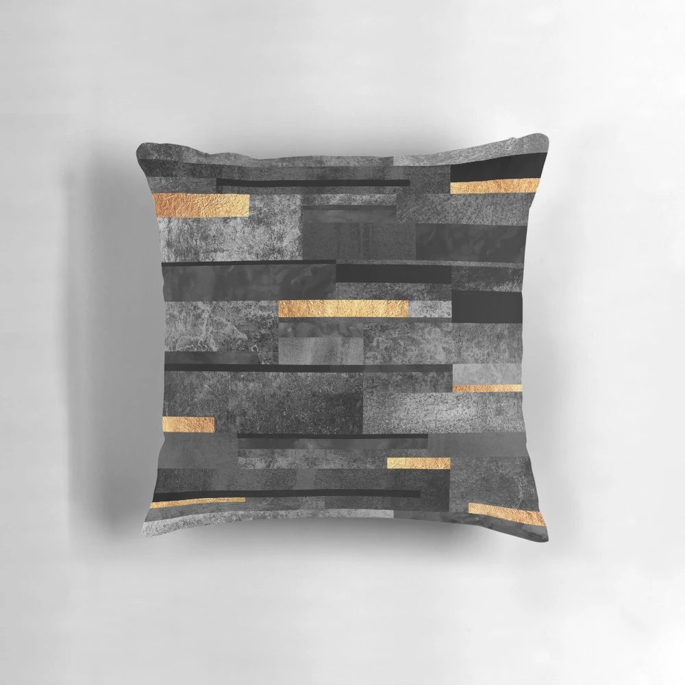 Urban black and gold decorative pillow with a modern, abstract graphic design
