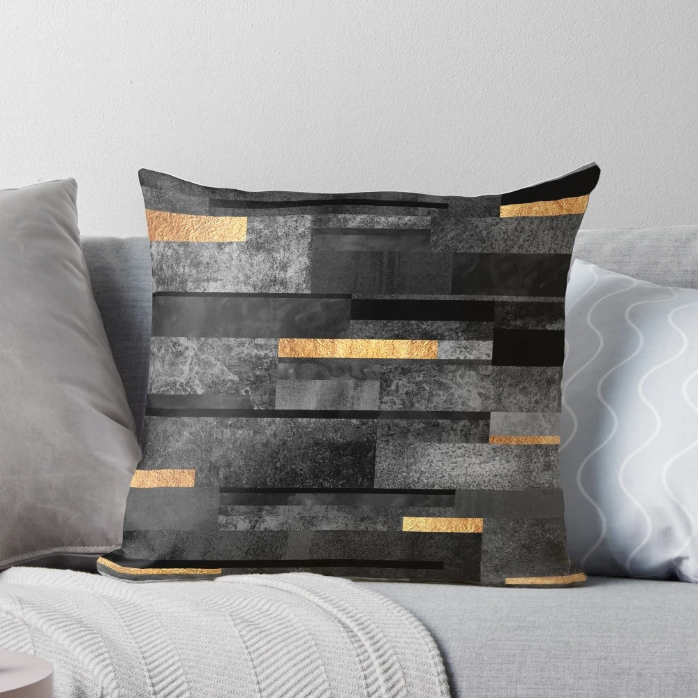 Urban black and gold decorative pillow with a modern, abstract graphic design