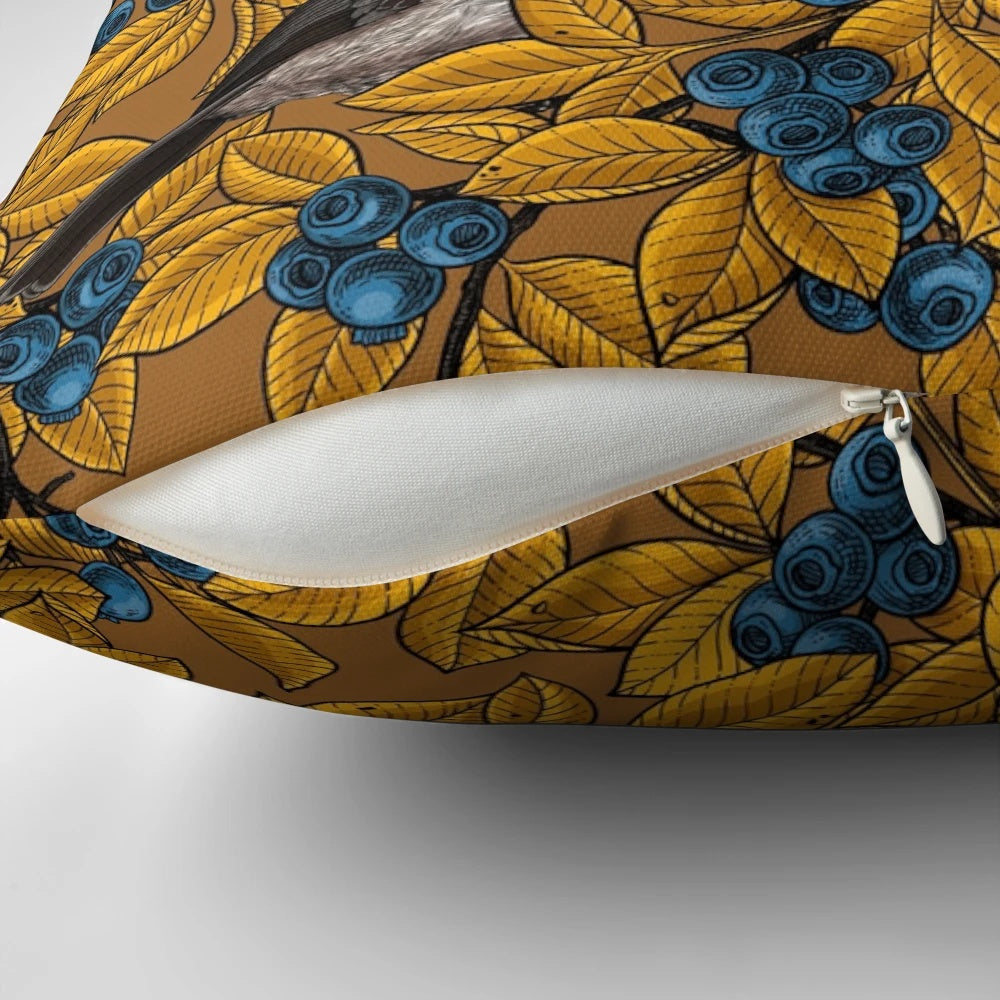Decorative throw pillow featuring a pattern of chickadee birds perched on blueberry branches.