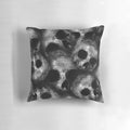 Dark skulls pattern on a decorative pillow, a creepy and gothic home accent.