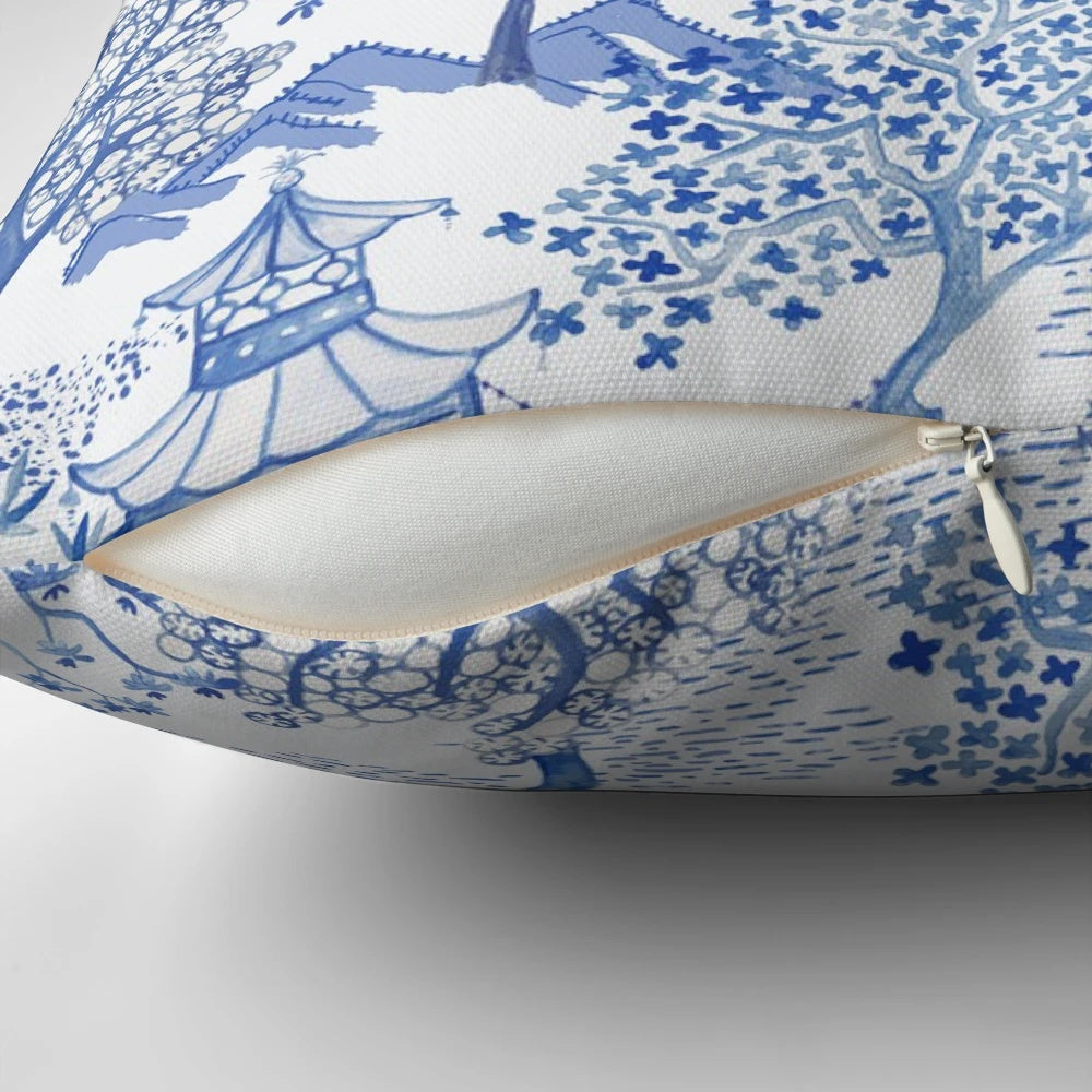 A blue and white throw pillow featuring a chinoiserie-style pagoda forest pattern.