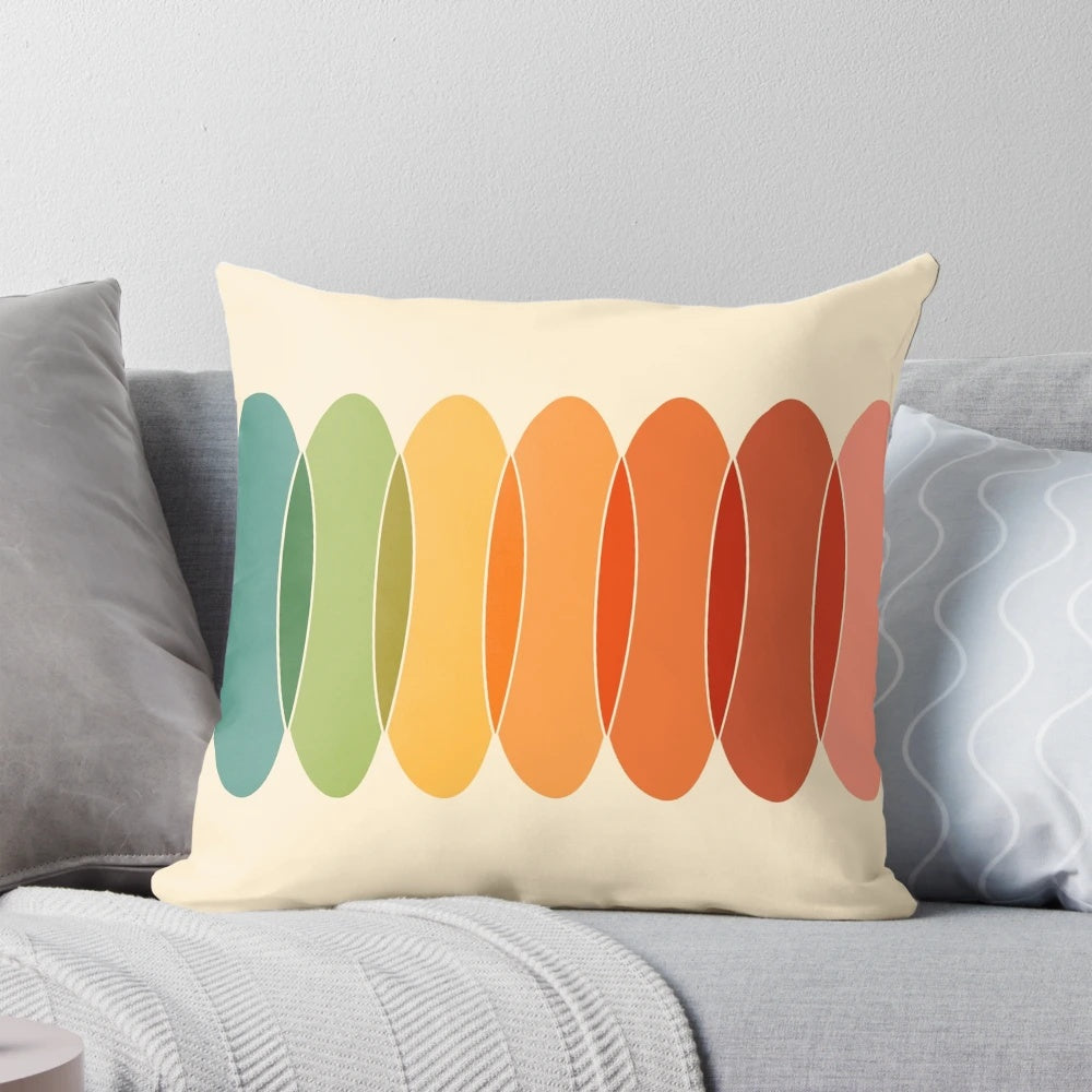 Colorful, geometric throw pillow with a horizontal pattern of overlapping ovals in a rainbow of colors.
